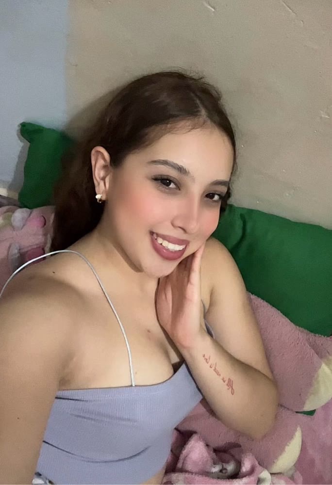 Smiling woman leaning on her hand, looking into the camera as if on a video call